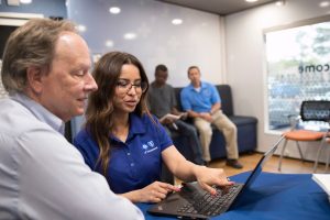 BlueCross employee speaks with someone in our mobile service unit.