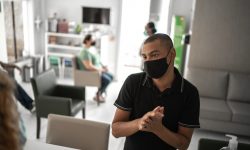 A man wearing a face mask in the lobby of a medical office