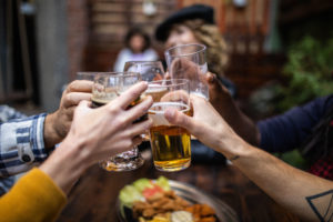 Group Of cheerful People Toasting at pub