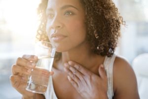 Mid adult woman drinking water