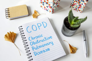 COPD Chronic Obstructive Pulmonary Disease written in notebook on white table