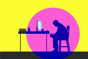 depressed man sitting in front of glowing computer screen.
