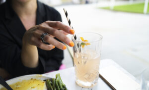 woman holding a juice cocktail drink during brunch lunch