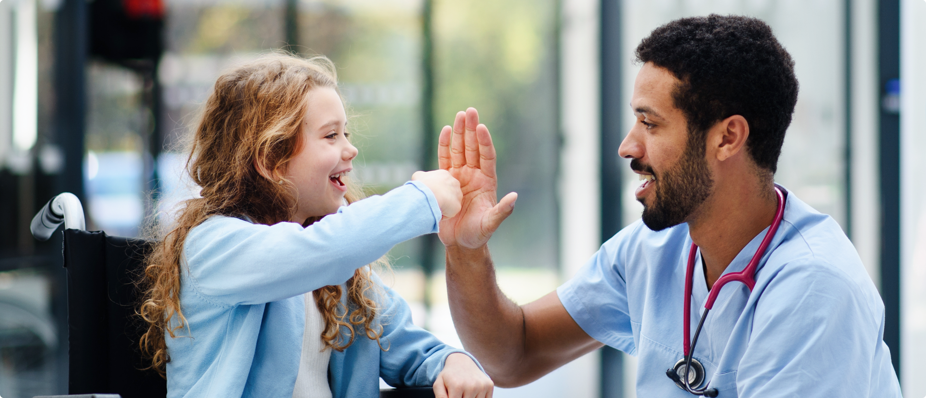 Doctor giving young patient high five