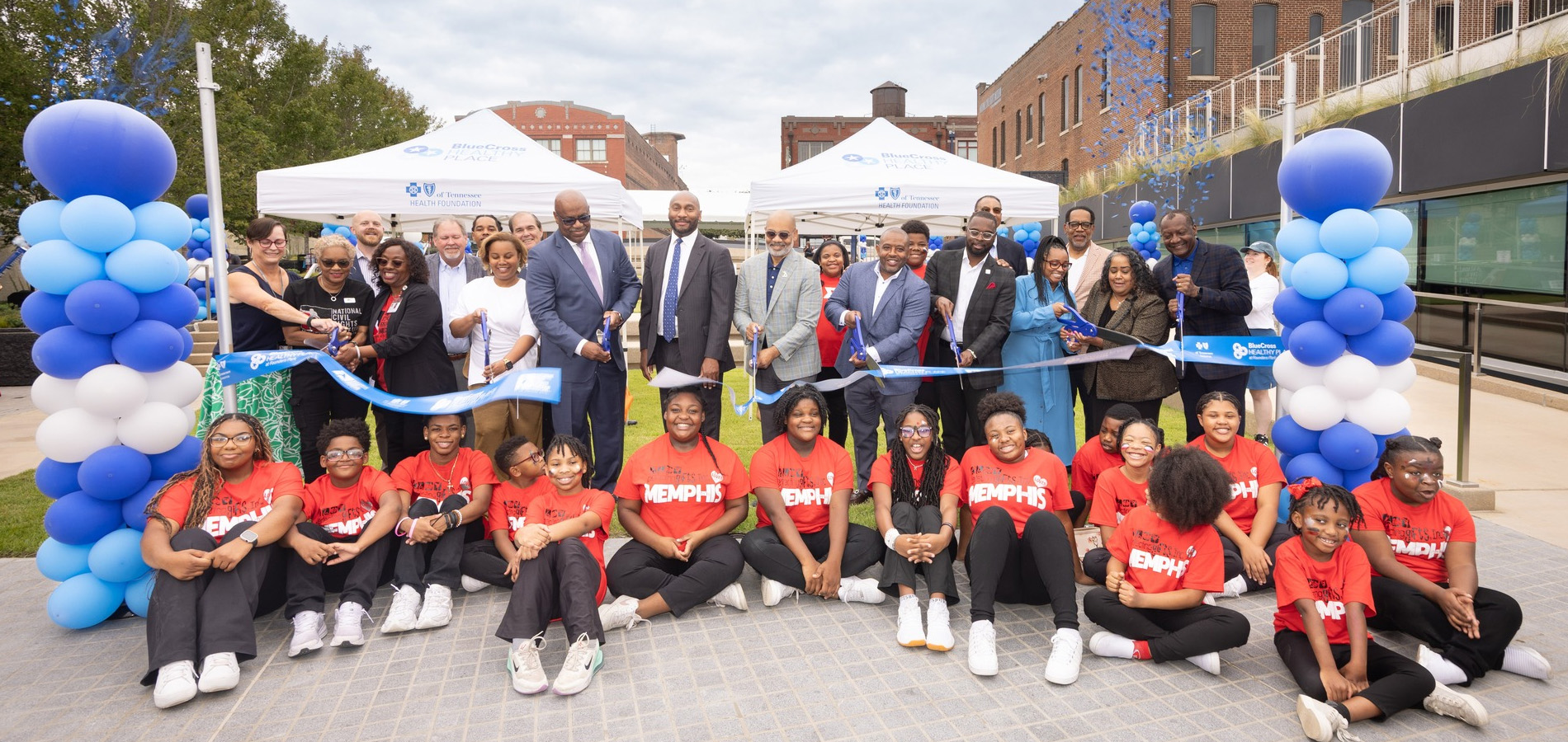 Ribbon cutting for park in Memphis with adult leaders and kids
