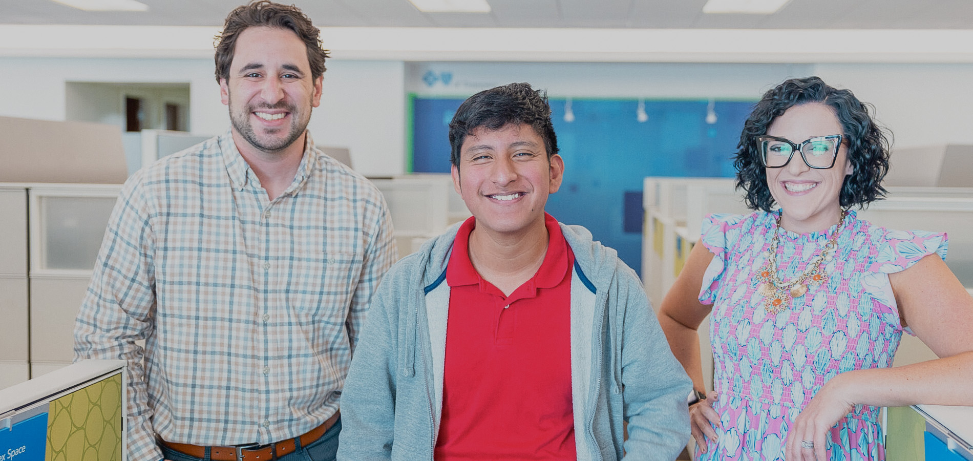 Photo of three individuals in an office setting